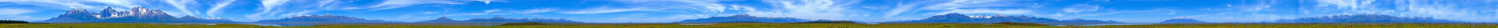 (A breathtaking, panoramic landscape) with towering, snow-capped mountains in the background, a serene lake reflecting the majestic peaks, and a lush, verdant meadow in the foreground dotted with vibrant wildflowers. The sky is a stunning azure blue, with wispy, cloud formations drifting lazily overhead, creating a sense of tranquility and wonder.